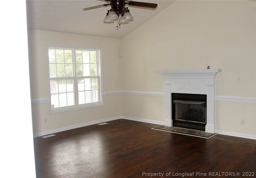 5836 Spreading Branch Road Hope Mills, NC 28348 - Photo 31 of 48 an empty room with wooden floor fan and windows