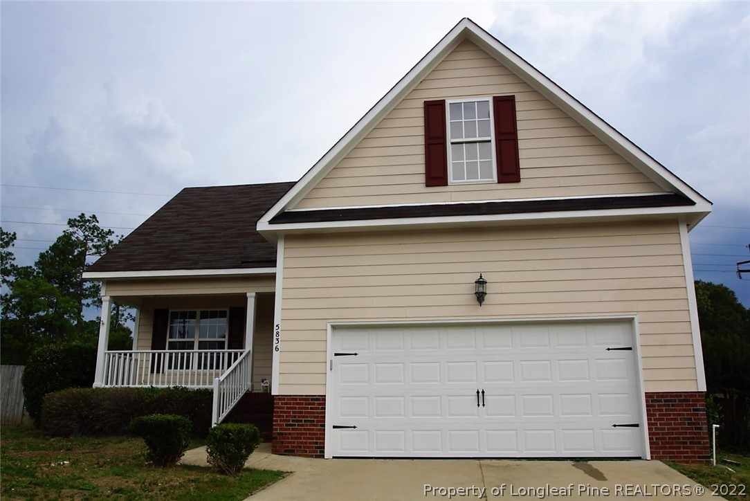 5836 Spreading Branch Road Hope Mills, NC 28348 - Photo 44 of 48 a front view of a house with a yard