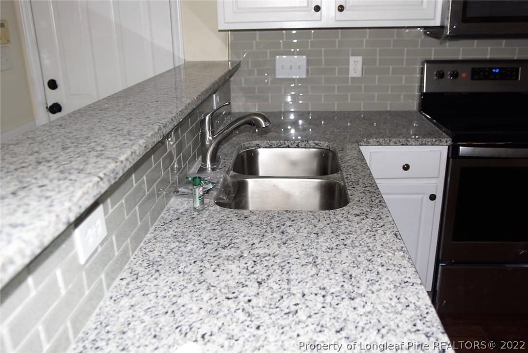5836 Spreading Branch Road Hope Mills, NC 28348 - Photo 10 of 48 a bathroom with a sink and a mirror