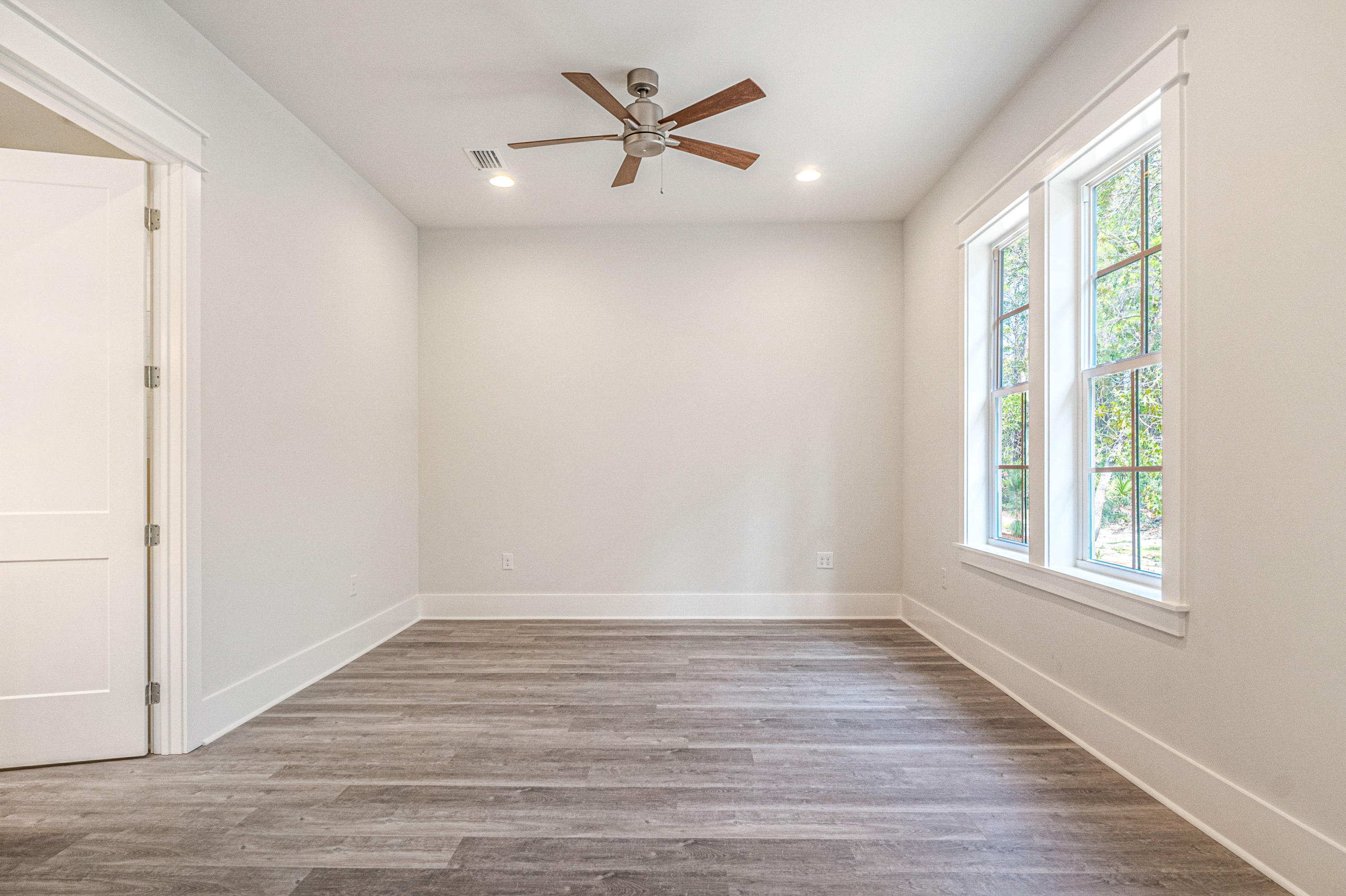 55 Matt's Way Santa Rosa Beach, FL 32459 - Photo 21 of 42 an empty room with wooden floor and windows