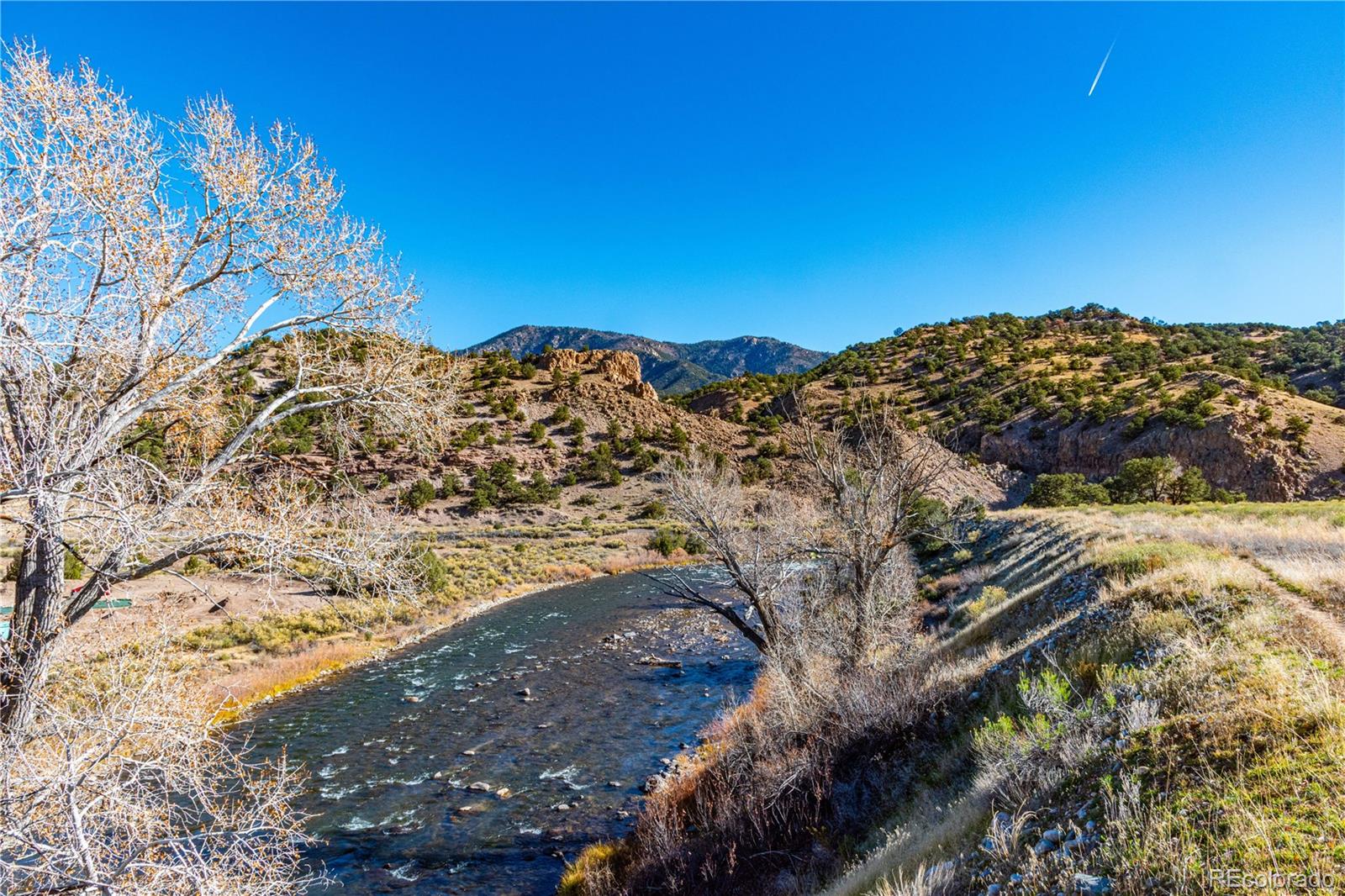 10817 Highway 50 Howard, CO 81233 - Photo 15 of 34 a view of a large building with a mountain in the background