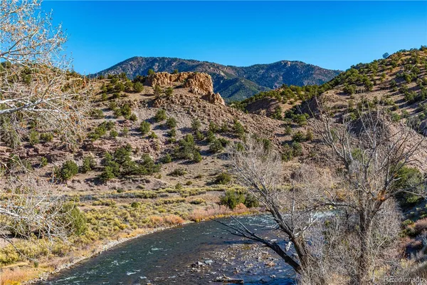 a view of a large mountain with a mountain in the background