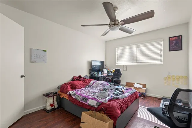 a bedroom with a bed and wooden floor