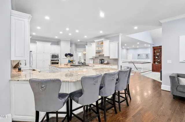 a bedroom with a large bed and a chandelier fan