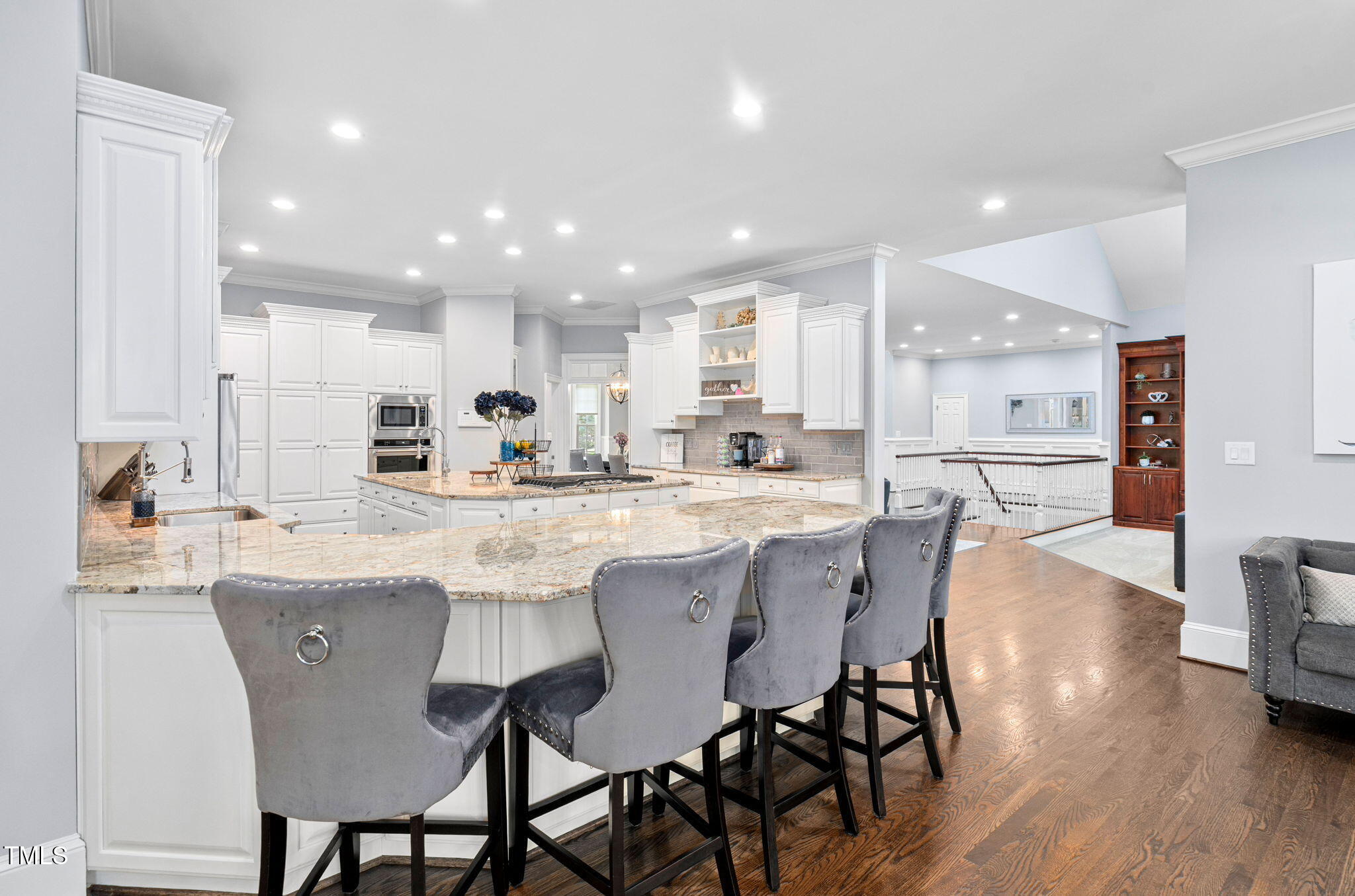 114 Kendleton Place Cary, NC 27518 - Photo 20 of 88 a kitchen with stainless steel appliances kitchen island granite countertop a dining table chairs and white cabinets