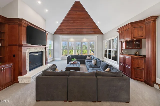 a large bed sitting in a bedroom next to a window
