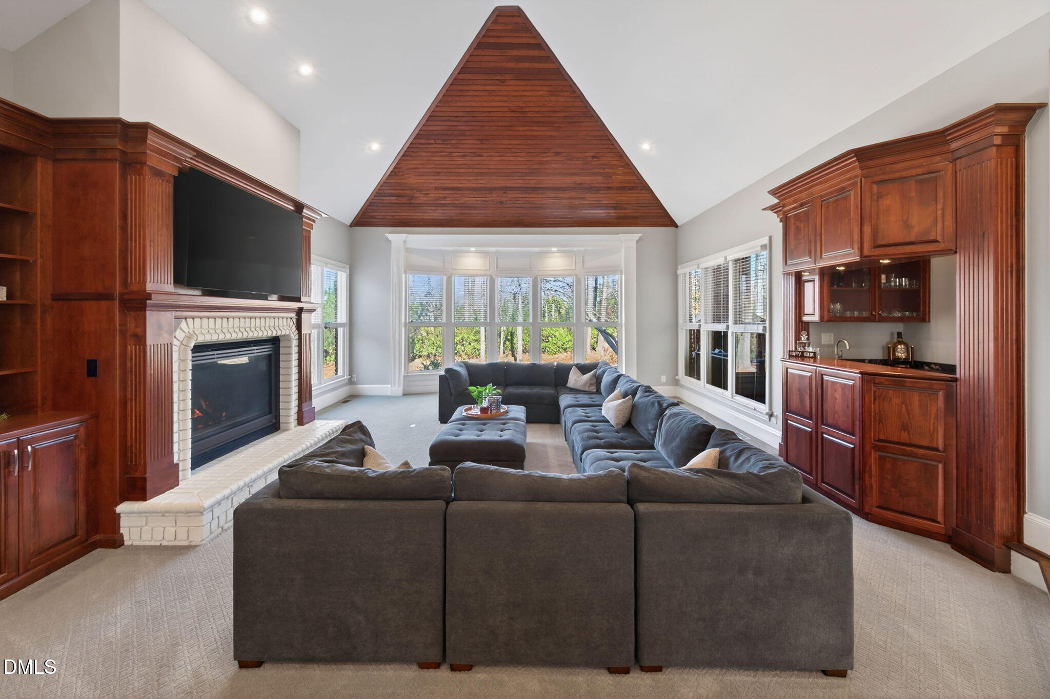 114 Kendleton Place Cary, NC 27518 - Photo 23 of 88 a living room with furniture a flat screen tv and a fireplace