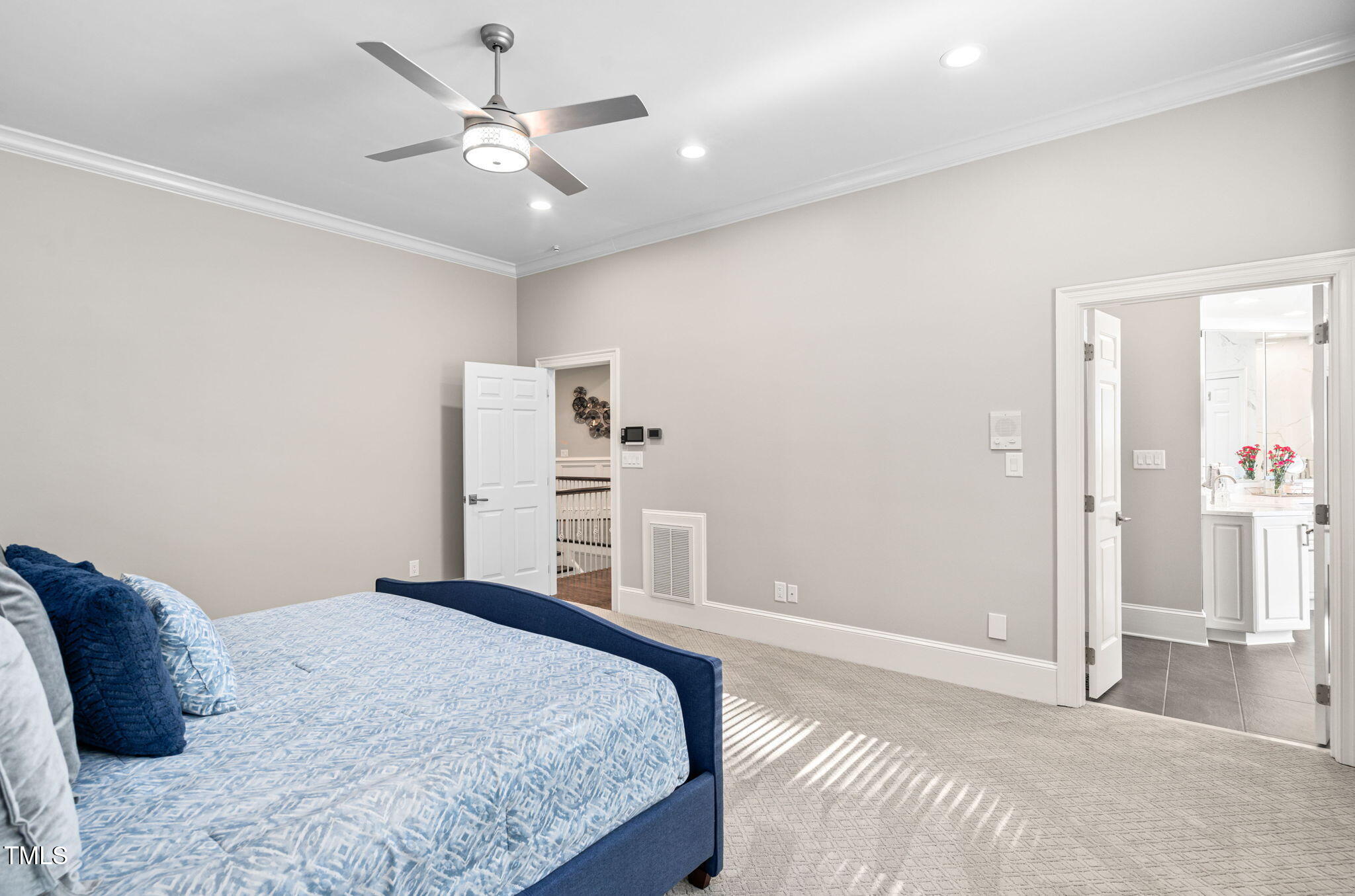 114 Kendleton Place Cary, NC 27518 - Photo 30 of 88 a bedroom with a large bed and a chandelier fan