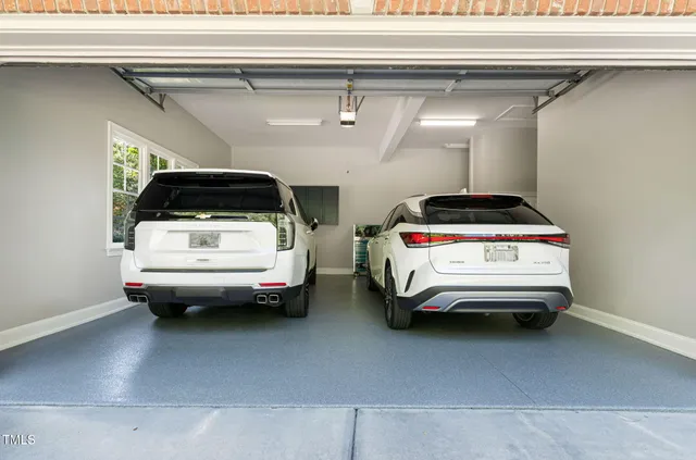 a view of a patio with table and chairs potted plants and large tree