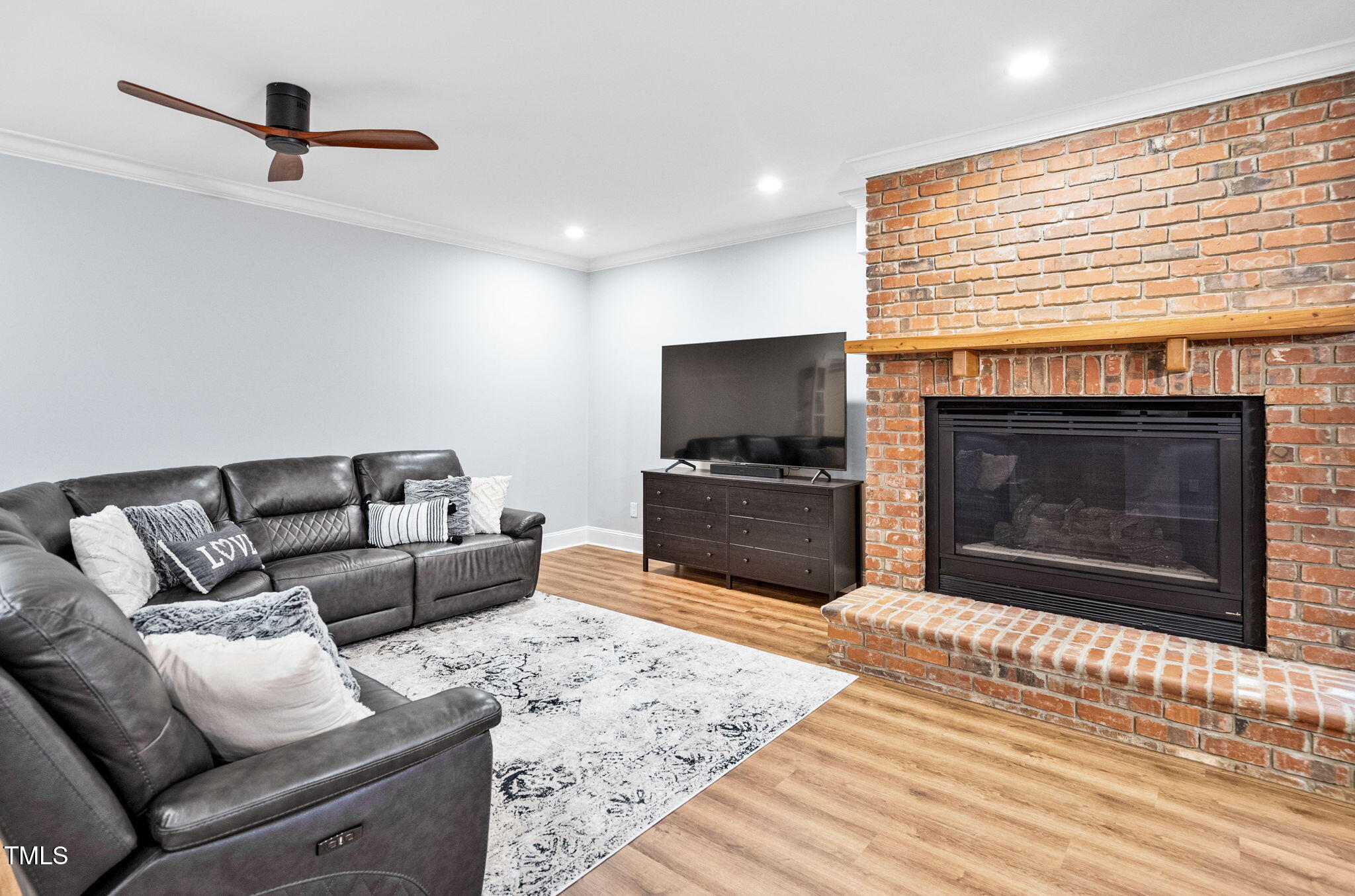 114 Kendleton Place Cary, NC 27518 - Photo 53 of 88 a living room with furniture a flat screen tv and a fireplace