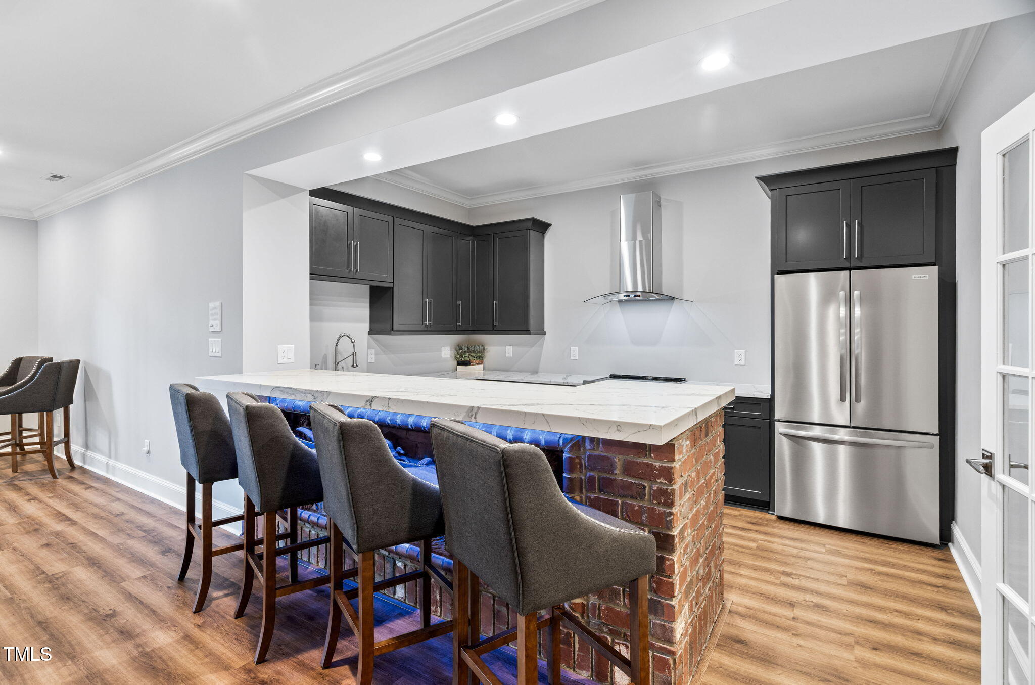 114 Kendleton Place Cary, NC 27518 - Photo 57 of 88 a kitchen with stainless steel appliances a dining table chairs refrigerator and sink
