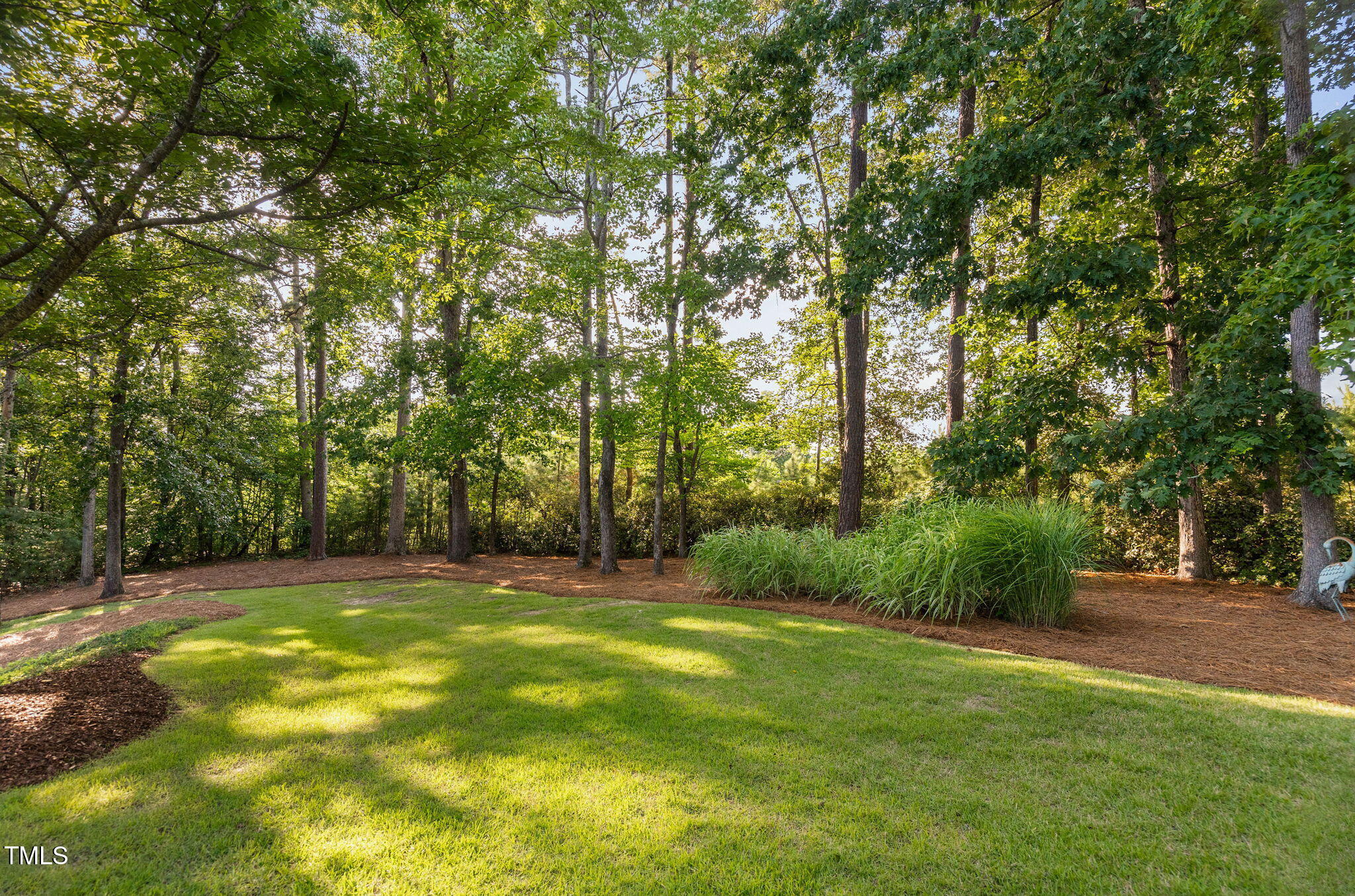 114 Kendleton Place Cary, NC 27518 - Photo 72 of 88 a view of a grassy field with trees in the background