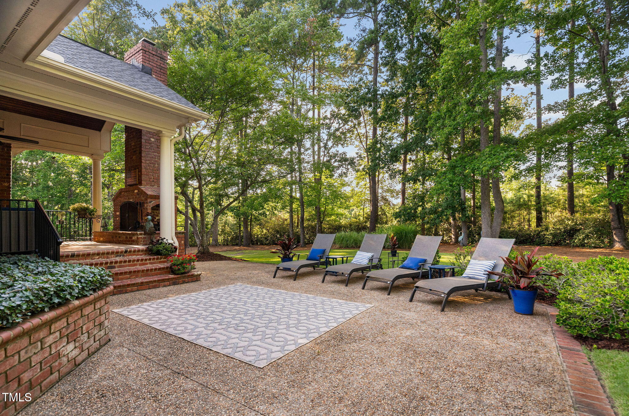 114 Kendleton Place Cary, NC 27518 - Photo 75 of 88 a view of a patio with table and chairs potted plants and large tree