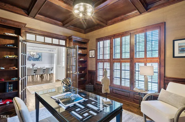 a view of a dining room with furniture a chandelier and wooden floor
