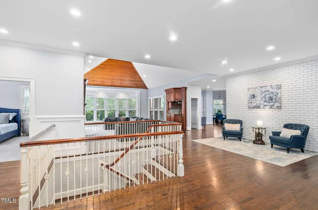 a kitchen with white cabinets appliances and wooden floor
