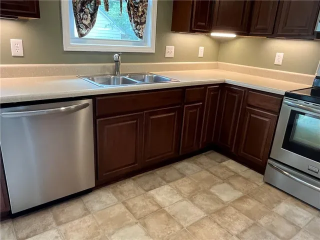 a kitchen with a sink and cabinets