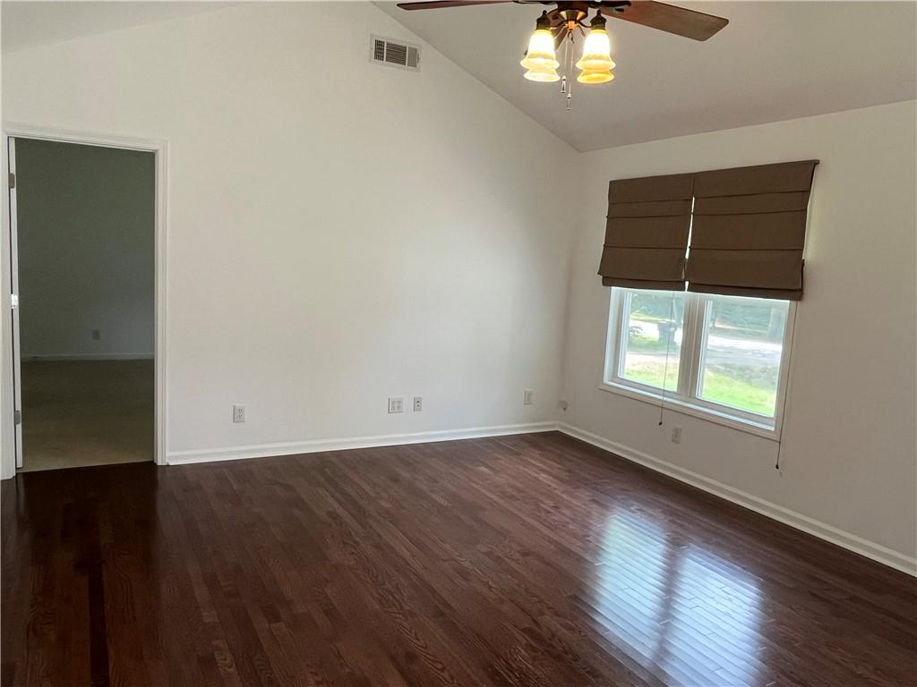 1429 Thyatira Brockton Road Jefferson, GA 30549 - Photo 16 of 46 an empty room with wooden floor chandelier and windows