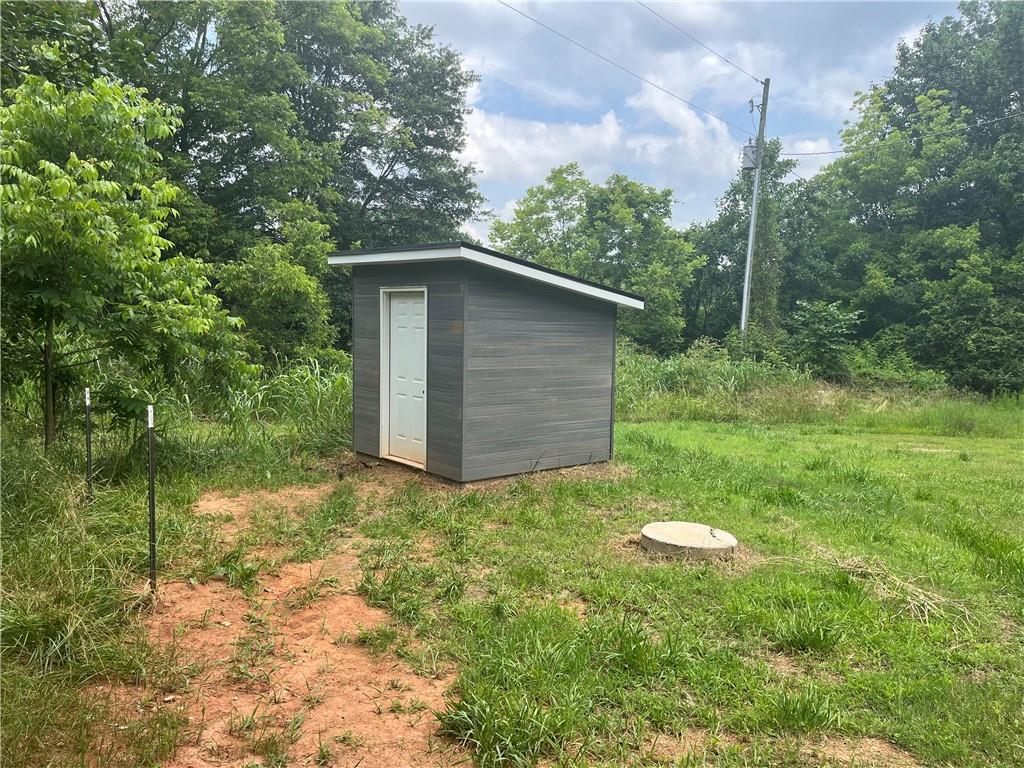 1429 Thyatira Brockton Road Jefferson, GA 30549 - Photo 37 of 46 a backyard of a house with plants and large tree
