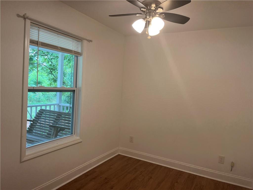 1429 Thyatira Brockton Road Jefferson, GA 30549 - Photo 41 of 46 a view of an empty room with wooden floor and a window