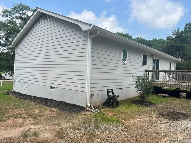 a view of a small house with a yard