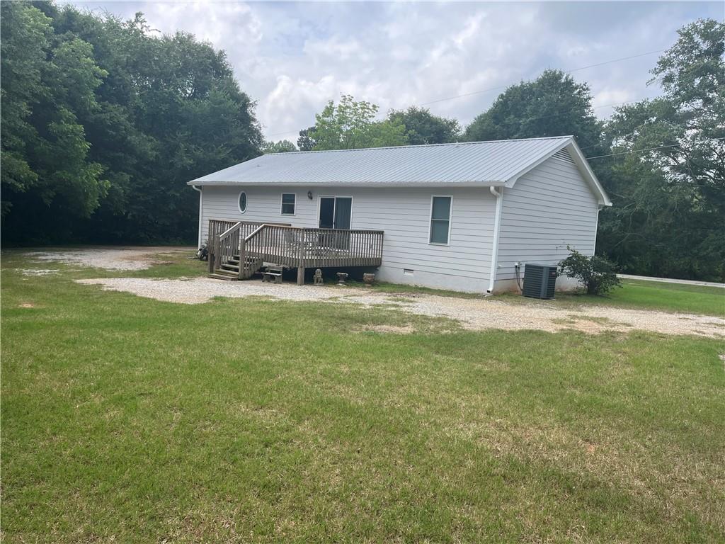 1429 Thyatira Brockton Road Jefferson, GA 30549 - Photo 7 of 46 a view of a house with a big yard and large trees