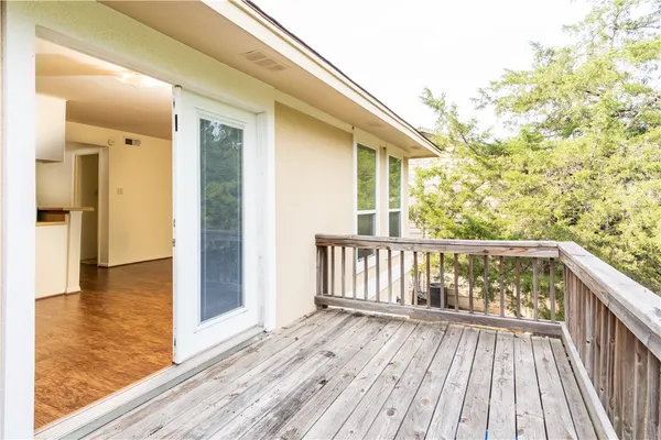 a view of balcony with wooden floor
