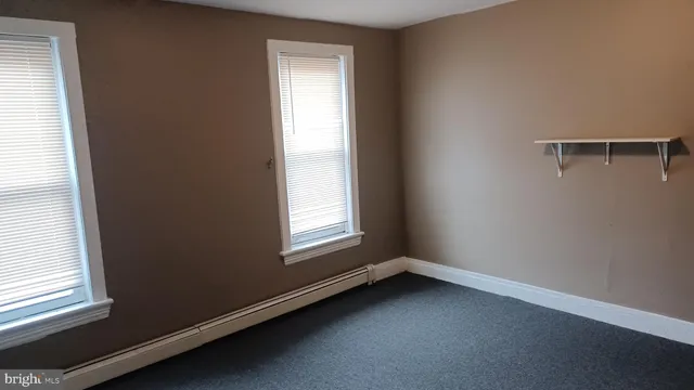 an empty room with a gallery and wooden floor