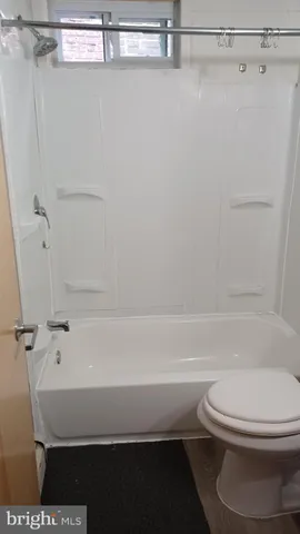 a bathroom with a toilet a sink and bathtub