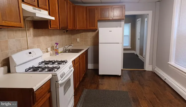a kitchen with a sink a stove and cabinets