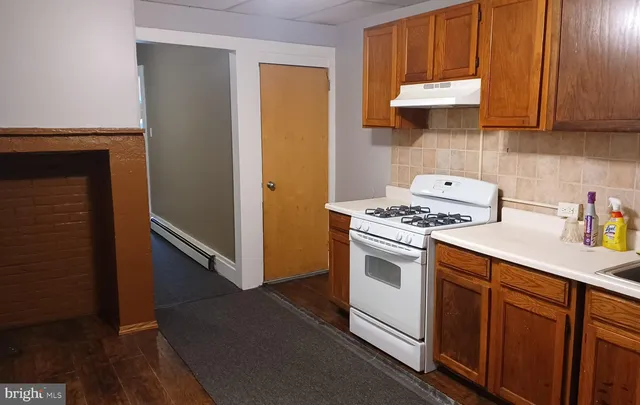 a kitchen with a stove and a refrigerator
