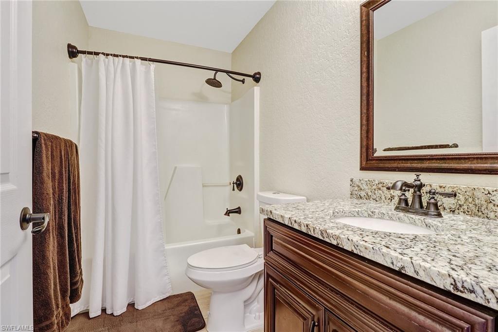 8426 Trillium Road Fort Myers, FL 33967 - Photo 9 of 18 a bathroom with a granite countertop sink toilet and shower