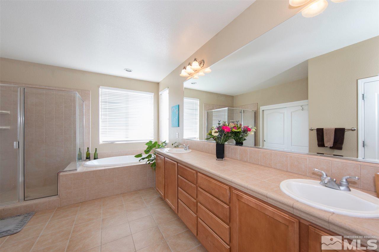 400 Parade Drive Reno, NV 89521 - Photo 14 of 24 a bathroom with a bathtub sink and a mirror