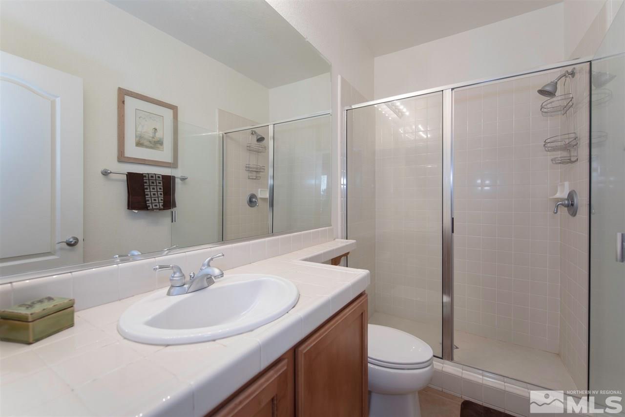 400 Parade Drive Reno, NV 89521 - Photo 17 of 24 a bathroom with a sink toilet and shower