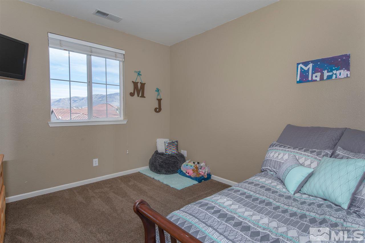 400 Parade Drive Reno, NV 89521 - Photo 19 of 24 a bedroom with a bed and a window