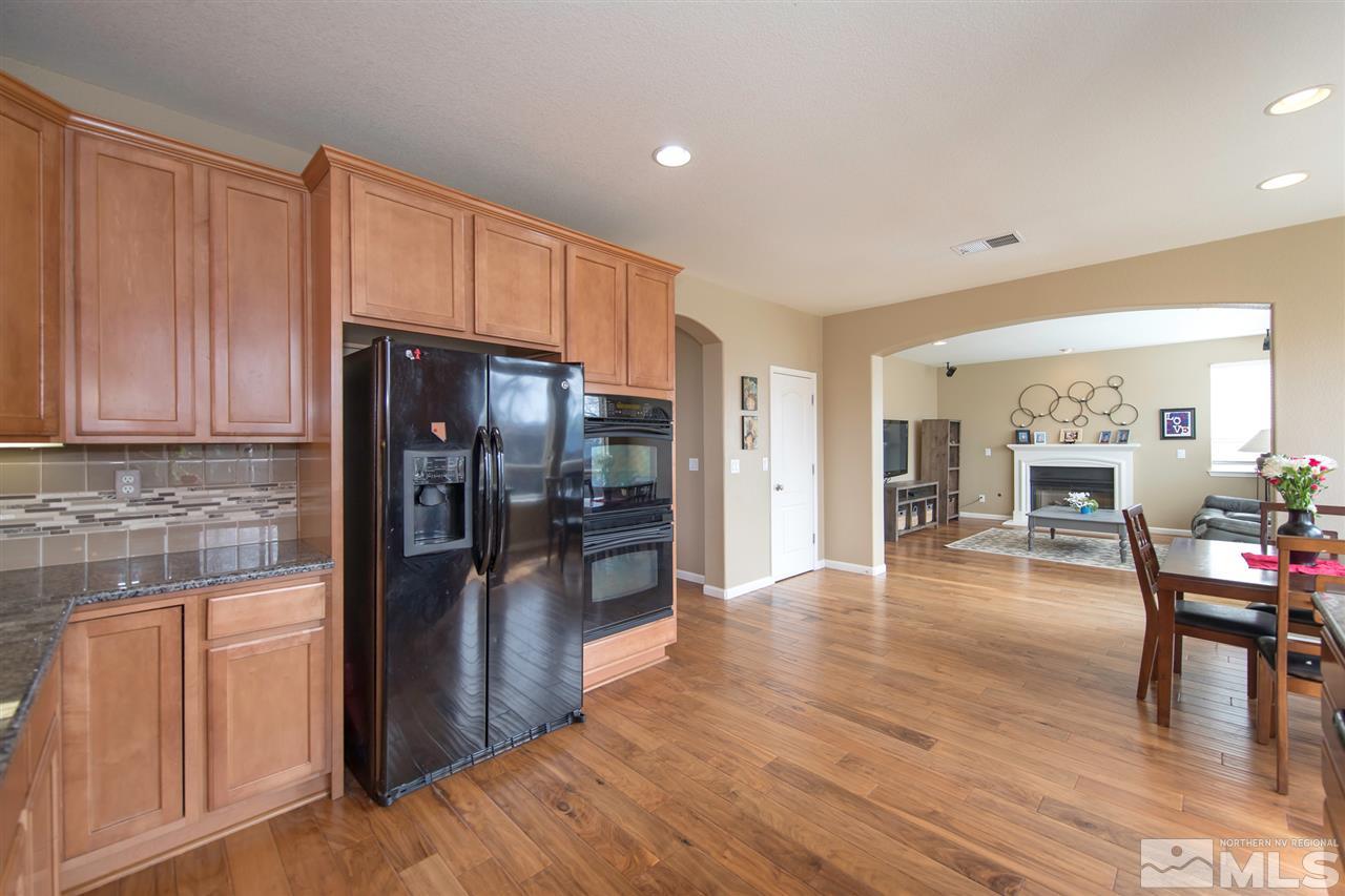 400 Parade Drive Reno, NV 89521 - Photo 5 of 24 a kitchen with stainless steel appliances granite countertop a refrigerator and stove top oven
