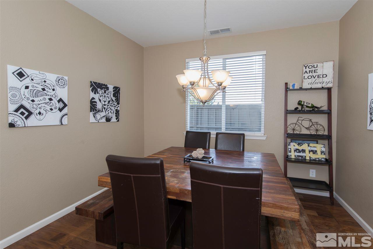 400 Parade Drive Reno, NV 89521 - Photo 10 of 24 a view of a dining room with furniture a chandelier and wooden floor