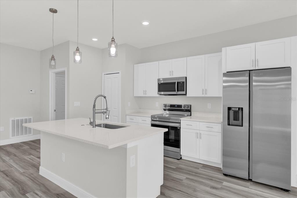 15684 Southwest 37th Circle Ocala, FL 34473 - Photo 12 of 34 a kitchen with stainless steel appliances a refrigerator sink and microwave