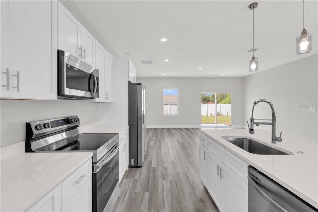 15684 Southwest 37th Circle Ocala, FL 34473 - Photo 13 of 34 a kitchen with sink a microwave and cabinets