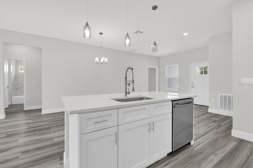 15684 Southwest 37th Circle Ocala, FL 34473 - Photo 14 of 34 a spacious bathroom with a granite countertop sink a toilet a mirror and shower