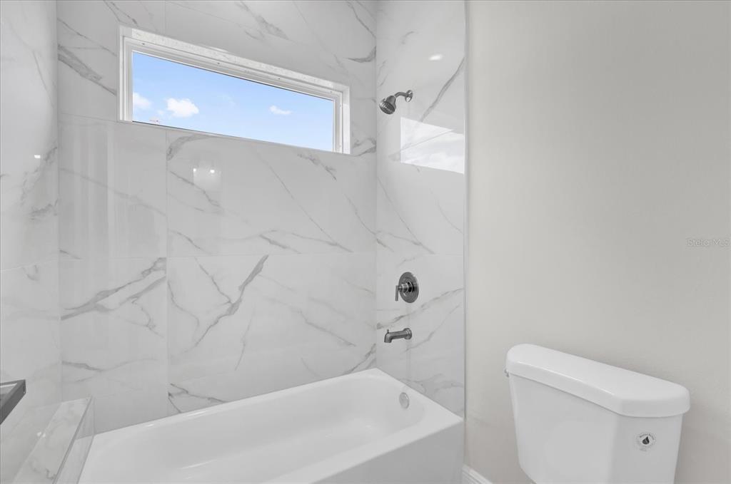 15684 Southwest 37th Circle Ocala, FL 34473 - Photo 19 of 34 a bathroom with a bathtub and a toilet