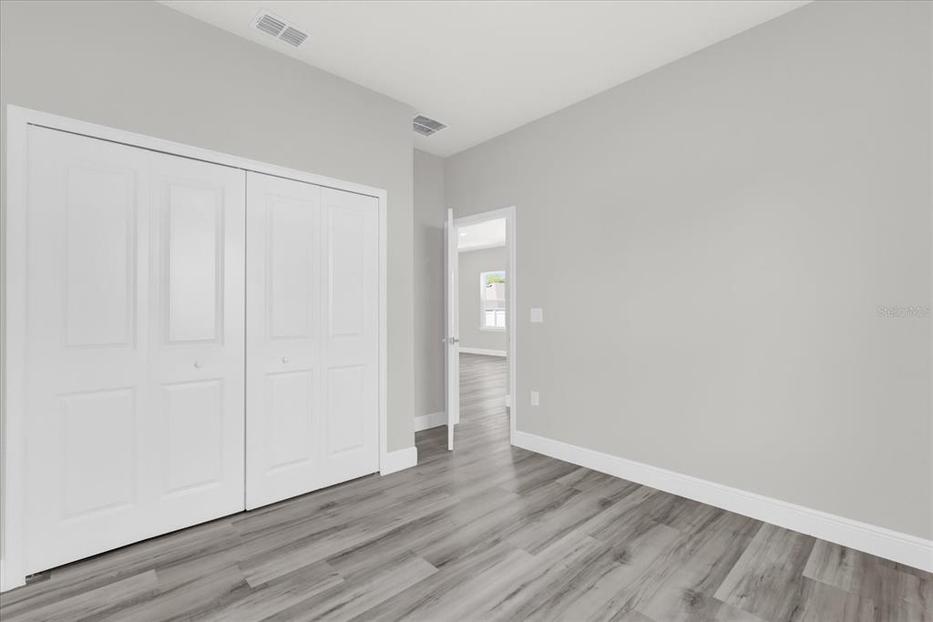 15684 Southwest 37th Circle Ocala, FL 34473 - Photo 21 of 34 a view of an empty room with wooden floor