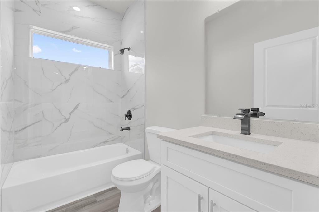 15684 Southwest 37th Circle Ocala, FL 34473 - Photo 22 of 34 a bathroom with a sink a toilet and a bathtub