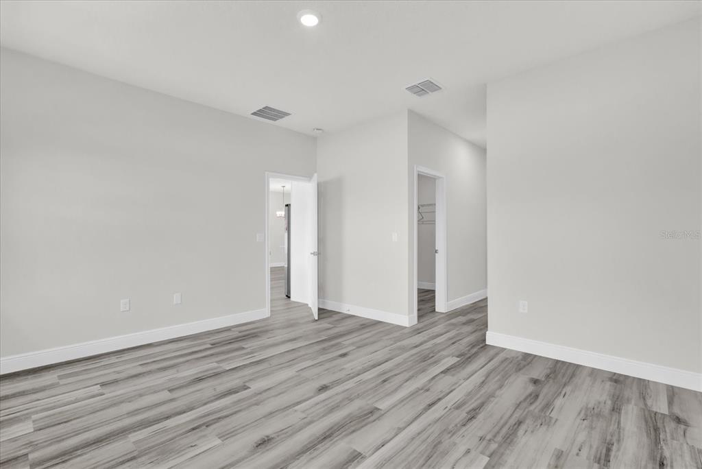 15684 Southwest 37th Circle Ocala, FL 34473 - Photo 26 of 34 a view of an empty room with wooden floor