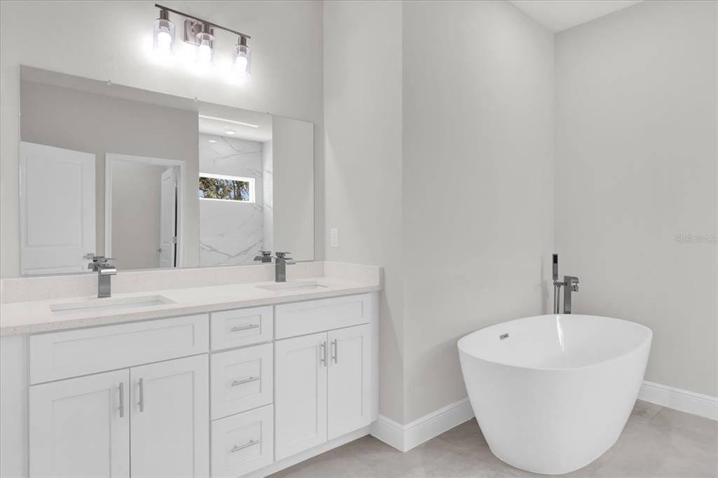 15684 Southwest 37th Circle Ocala, FL 34473 - Photo 28 of 34 a bathroom with a double vanity sink and a mirror