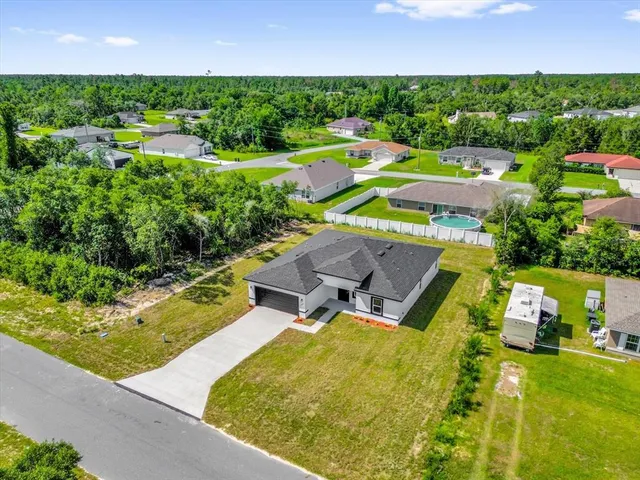 an aerial view of a house with a garden