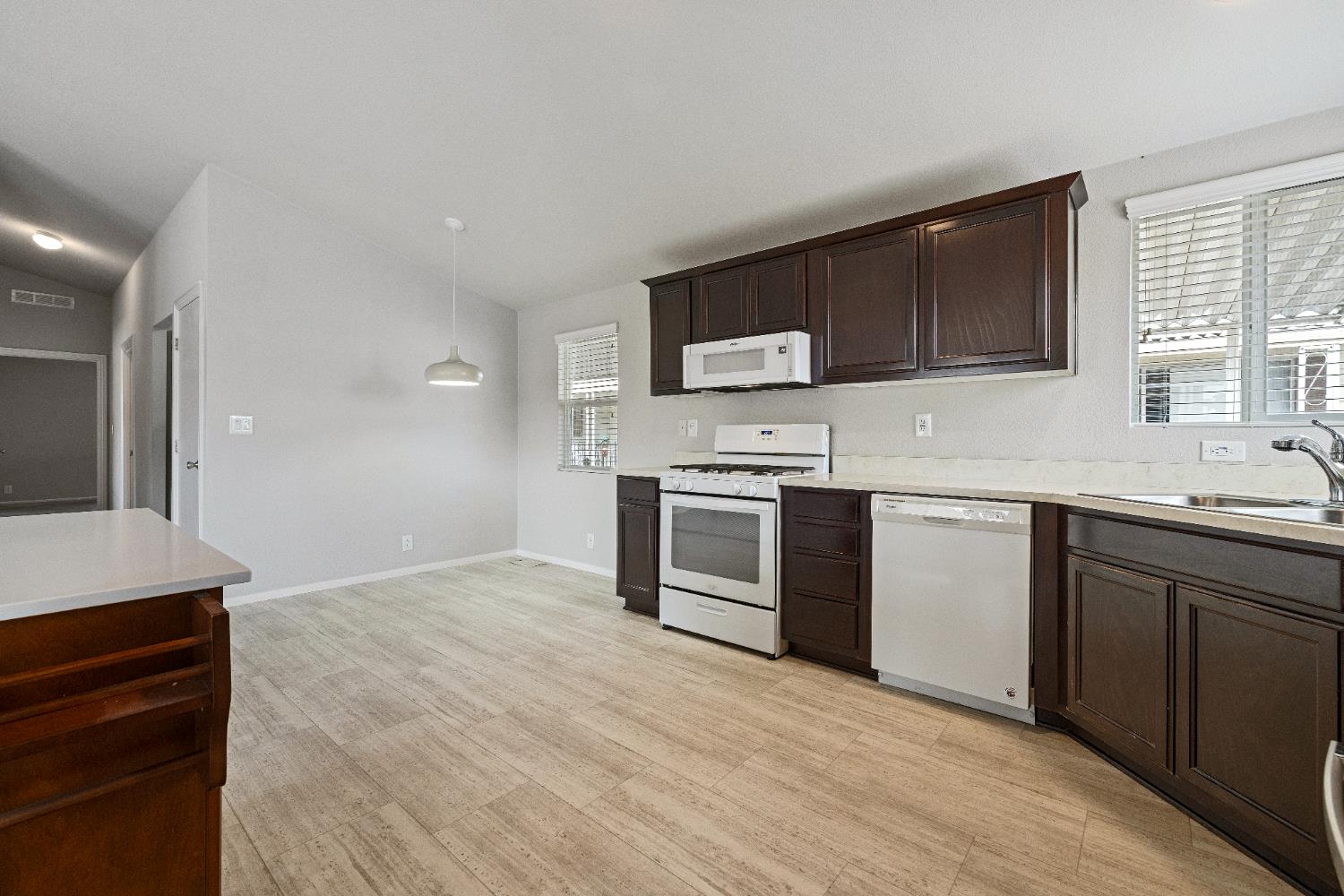 2621 Prescott, Unit 92 Modesto, CA 95350 - Photo 11 of 25 a kitchen with stainless steel appliances a stove sink and microwave