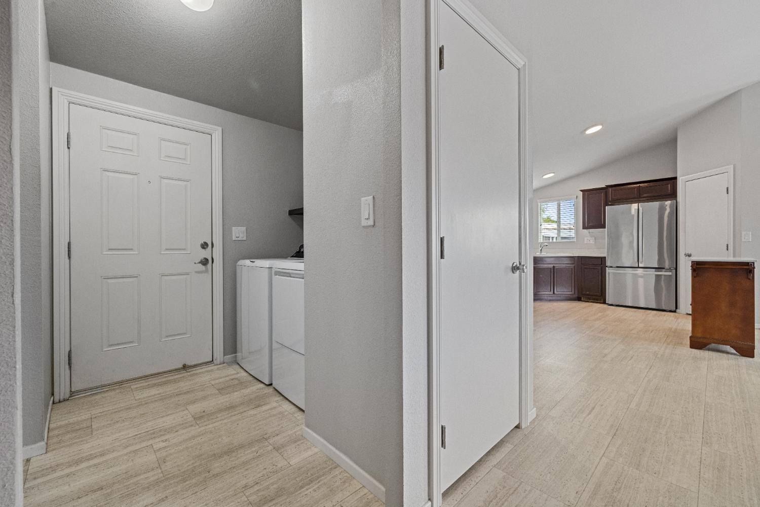 2621 Prescott, Unit 92 Modesto, CA 95350 - Photo 13 of 25 an empty room with kitchen and refrigerator