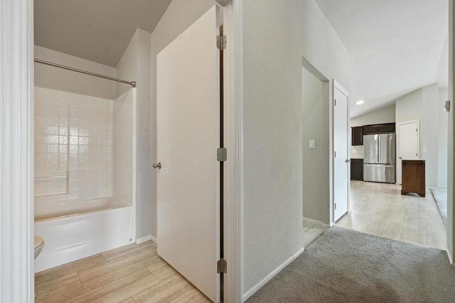 2621 Prescott, Unit 92 Modesto, CA 95350 - Photo 14 of 25 a view of a hallway with wooden floor and entryway
