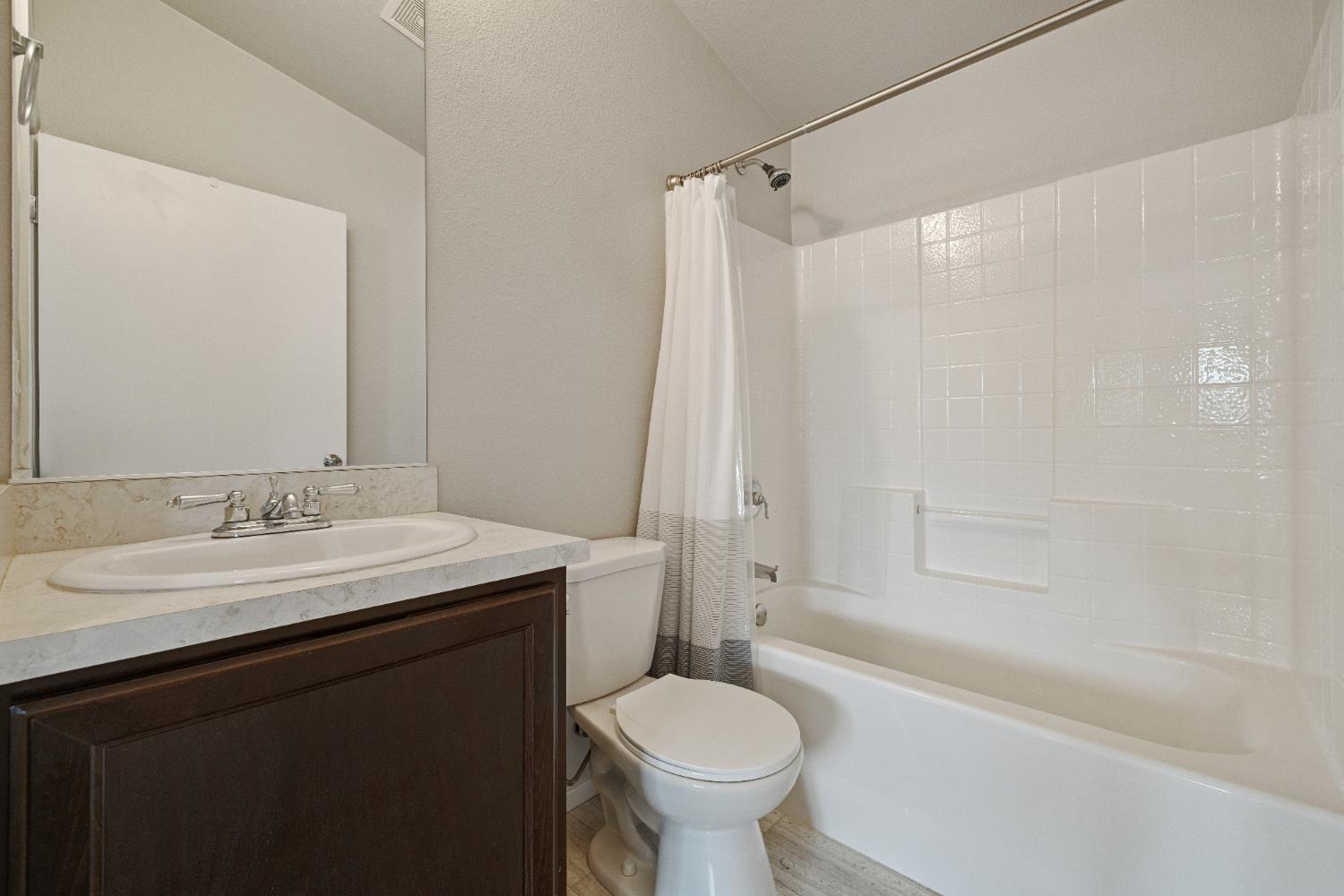 2621 Prescott, Unit 92 Modesto, CA 95350 - Photo 15 of 25 a bathroom with a sink toilet tub and shower