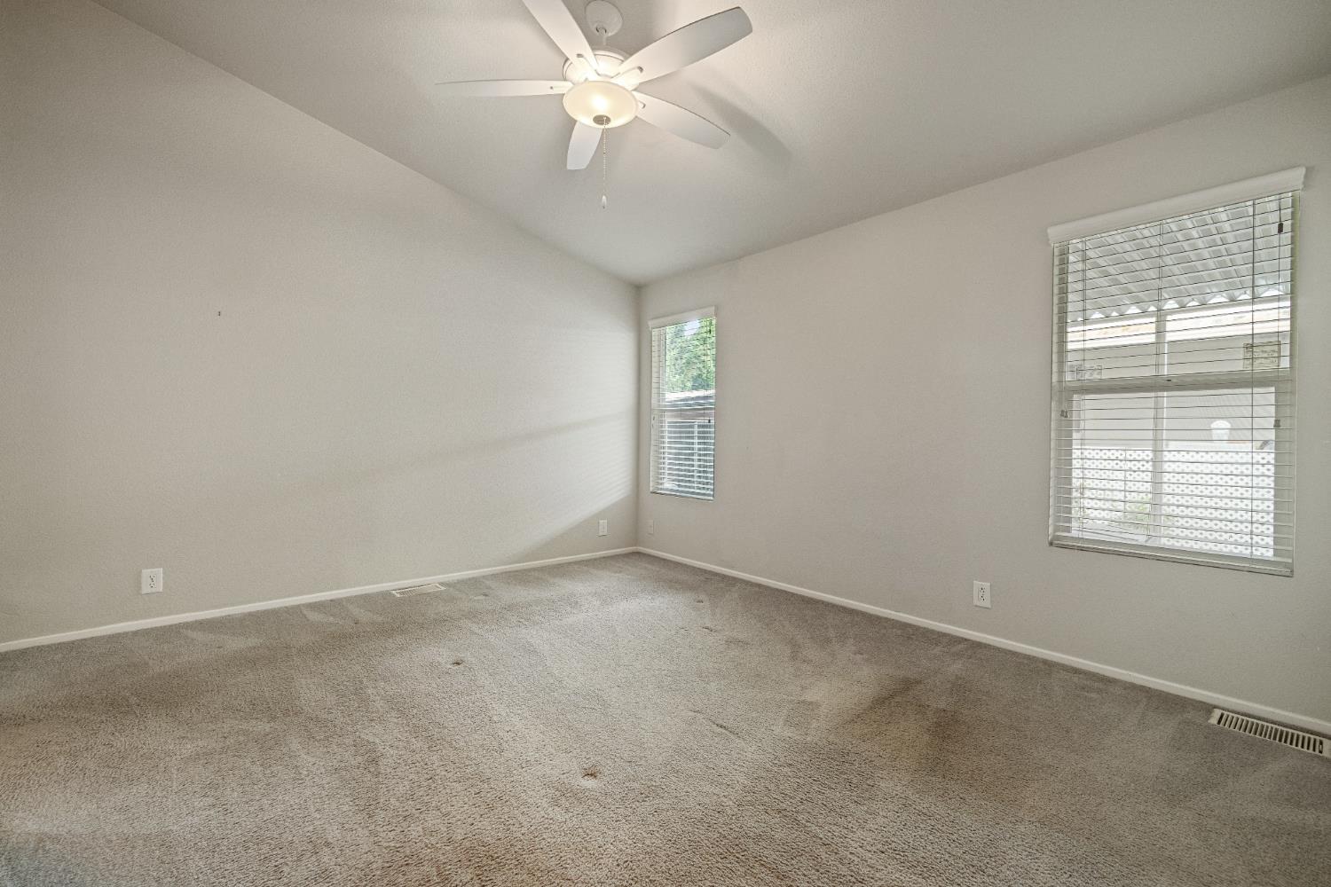 2621 Prescott, Unit 92 Modesto, CA 95350 - Photo 21 of 25 an empty room with windows and fan